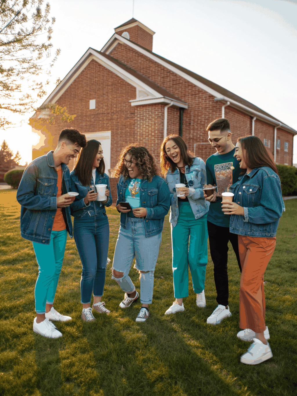 People smiling and conversing warmly with coffee after a community service